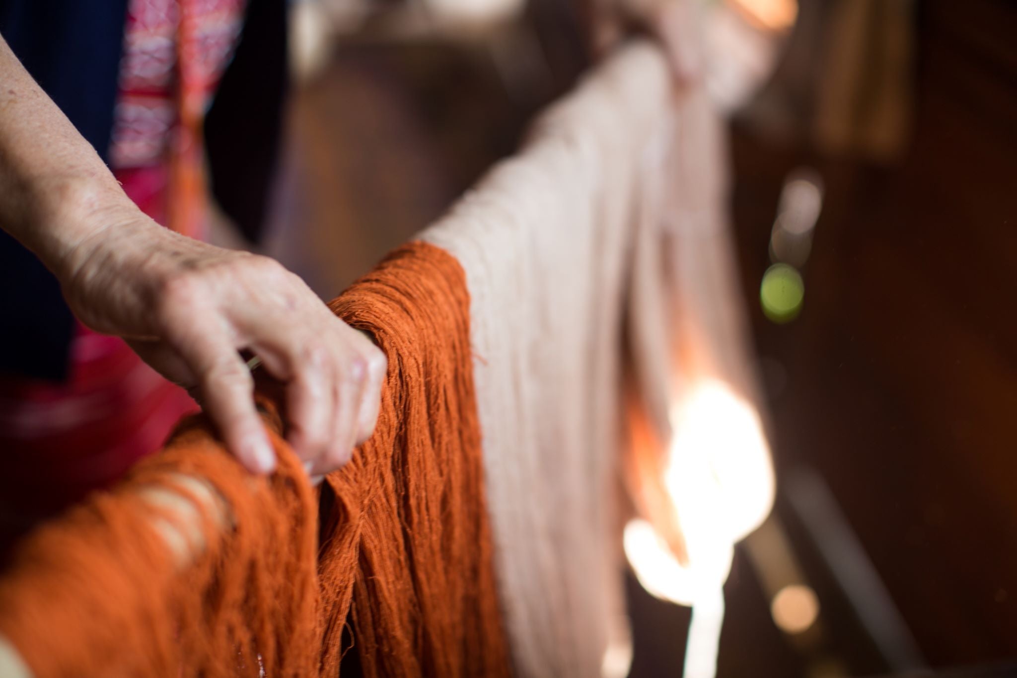 Strings of fabric in the process of being dyed by hand in Thailand