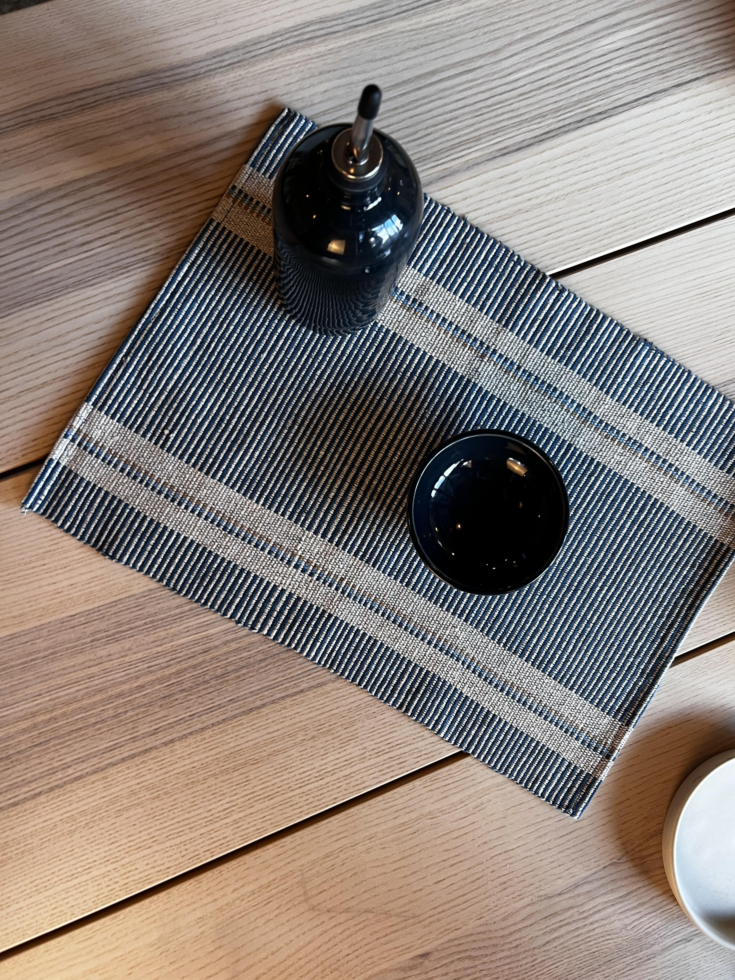 Stripped placemat on a table with dishes on it